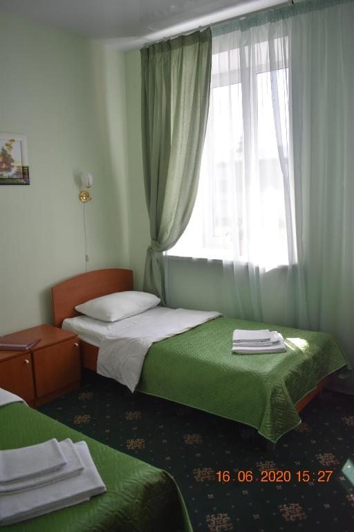 Двухместный (Двухместный номер с 2 отдельными кроватями и душем) отеля Бизнес Отель, Череповец