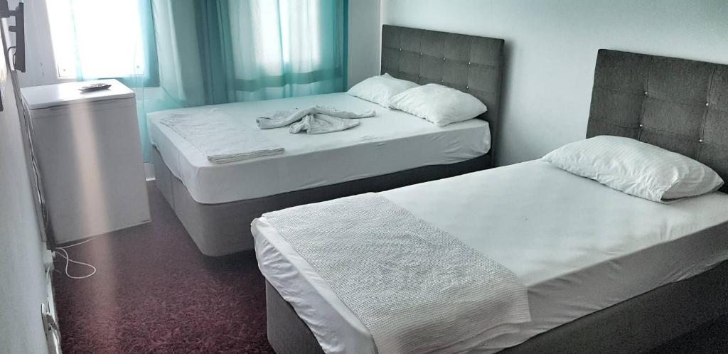 Двухместный (Стандартный двухместный номер с 2 отдельными кроватями) отеля Merkez Kumsal Pansiyon, Бодрум