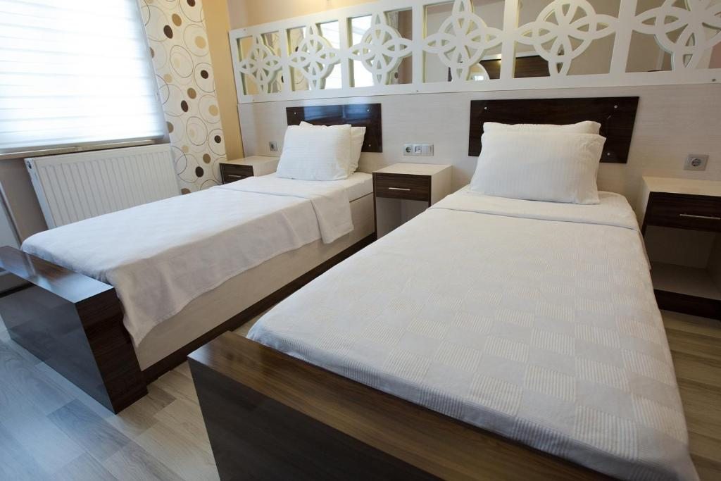 Двухместный (Двухместный номер Делюкс с 1 кроватью или 2 отдельными кроватями и балконом) гостевого дома Ozbay Hotel, Памуккале