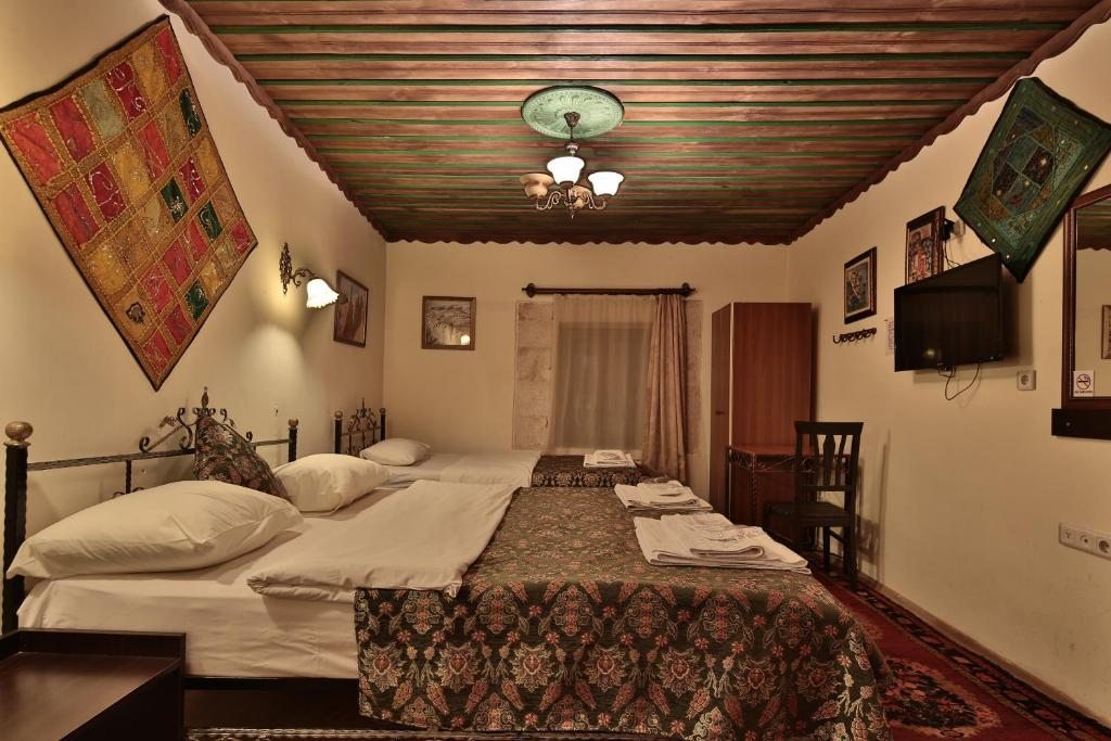 Трехместный (Трехместный номер) отеля Caravanserai Cave Hotel, Гереме