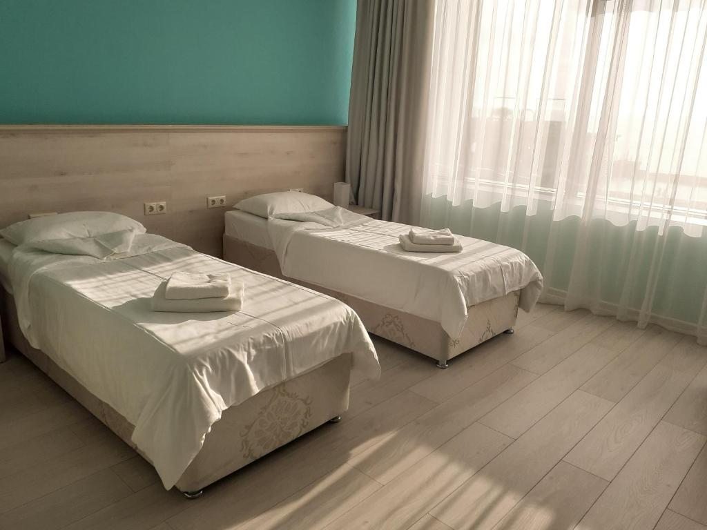 Двухместный (Двухместный номер Делюкс с 1 кроватью или 2 отдельными кроватями и видом на море) отеля Портофино, Сочи