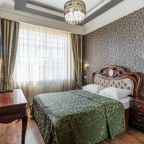 Номер с двуспальной кроватью, телевизором, рабочим столом.
