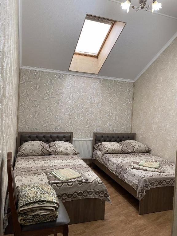 Двухместный (Двухместный номер с 2 отдельными кроватями и собственной ванной комнатой) мотеля Guest House Uyut, Аксай