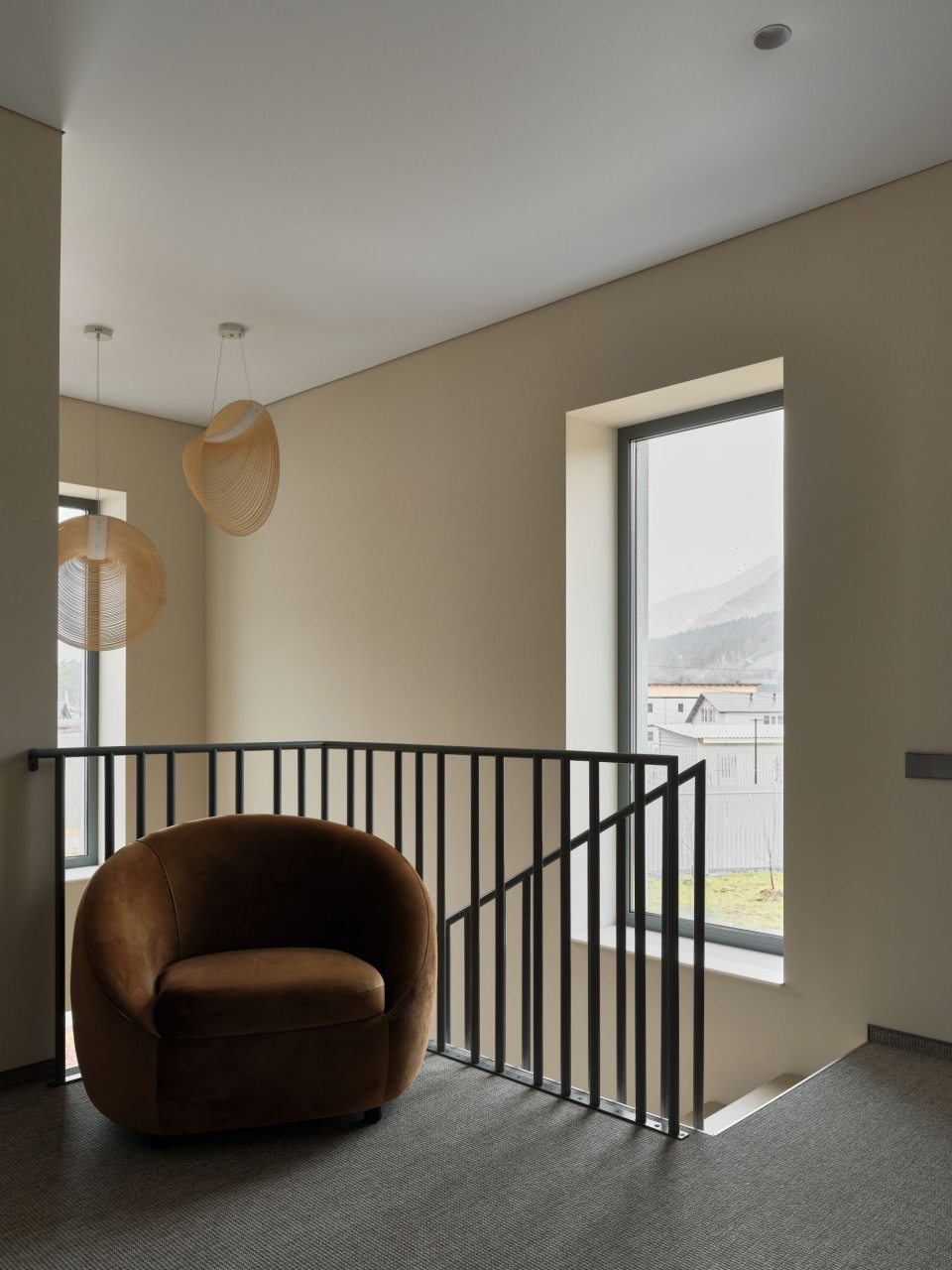 Двухэтажный дом в отдалении с видом на сад и горы.