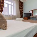 Окно с красными шторами и белыми занавесками.