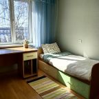 Спальная комната с одноместной кроватью и рабочей зоной.